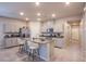 Well-lit kitchen with gray cabinets, granite counters, stainless steel appliances, and an island with seating at 10281 Sequoia Falls Pl, Las Vegas, NV 89149