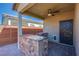 Covered outdoor kitchen with a built-in barbecue grill and countertop at 10281 Sequoia Falls Pl, Las Vegas, NV 89149
