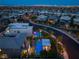 Aerial view of a modern home with a private pool and a lush backyard at twilight at 10313 Jade Point Dr, Las Vegas, NV 89135