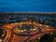 Wide aerial view of a residential neighborhood with landscaped roundabouts and a city skyline at 10313 Jade Point Dr, Las Vegas, NV 89135