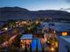 Beautiful aerial view of this backyard with a pool, kitchen, lounge area and mountain backdrop at twilight at 10313 Jade Point Dr, Las Vegas, NV 89135