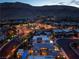 Stunning aerial view of a modern home with a sparkling pool and mountain views at twilight at 10313 Jade Point Dr, Las Vegas, NV 89135