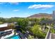 Spacious backyard featuring a pool, patio, lush landscaping, and serene mountain views at 10313 Jade Point Dr, Las Vegas, NV 89135