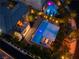 Night aerial view showcasing a modern home's backyard with two pools and patio spaces at 10313 Jade Point Dr, Las Vegas, NV 89135