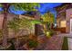 Serene backyard featuring a decorative fountain, lush landscaping, and lounge chairs for ultimate relaxation at 10313 Jade Point Dr, Las Vegas, NV 89135