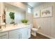 Neutral toned bathroom featuring framed art, modern fixtures, and a vessel sink at 10313 Jade Point Dr, Las Vegas, NV 89135