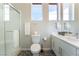 Modern bathroom featuring pebble flooring, a glass enclosed shower, and dual vanities at 10313 Jade Point Dr, Las Vegas, NV 89135