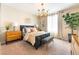 Comfortable bedroom with contemporary decor, stylish lighting, and a large window at 10313 Jade Point Dr, Las Vegas, NV 89135