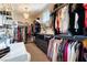 Well-organized walk-in closet with ample shelving, drawers, and a stylish chandelier at 10313 Jade Point Dr, Las Vegas, NV 89135