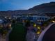 Aerial view of neighborhood park, walking paths, and modern homes at dusk at 10313 Jade Point Dr, Las Vegas, NV 89135