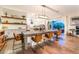 The open-concept dining room features a large dining table and flows into a modern kitchen at 10313 Jade Point Dr, Las Vegas, NV 89135