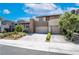 A modern home featuring desert landscaping, neutral tones, and a convenient two-car garage at 10313 Jade Point Dr, Las Vegas, NV 89135