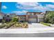 Contemporary home with well-maintained landscaping, a two-car garage, and a neutral color palette at 10313 Jade Point Dr, Las Vegas, NV 89135
