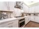 Bright kitchen featuring white cabinets, marble countertops, and stainless steel appliances, perfect for modern living at 10313 Jade Point Dr, Las Vegas, NV 89135