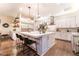 Bright kitchen with marble island, pendant lighting, stainless steel appliances, and view to outdoor patio at 10313 Jade Point Dr, Las Vegas, NV 89135