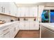 Bright kitchen featuring white cabinets, marble countertops, and stainless steel appliances at 10313 Jade Point Dr, Las Vegas, NV 89135
