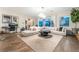 Bright living room with a large sectional couch, stylish decor, and views of the backyard at 10313 Jade Point Dr, Las Vegas, NV 89135