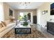 Bright living room with a shaggy rug, contemporary lighting, and patio access at 10313 Jade Point Dr, Las Vegas, NV 89135