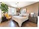 Bright main bedroom boasts a stylish chandelier, modern decor, and ensuite bath access at 10313 Jade Point Dr, Las Vegas, NV 89135