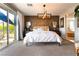Bright main bedroom with wood accent wall, sliding glass doors, and modern decor at 10313 Jade Point Dr, Las Vegas, NV 89135