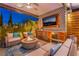 Comfortable outdoor space featuring a fire pit, TV, and outdoor kitchen with modern features at 10313 Jade Point Dr, Las Vegas, NV 89135