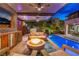 Beautiful outdoor living area with a fire pit and pool, creating a perfect ambiance for relaxation and entertainment at 10313 Jade Point Dr, Las Vegas, NV 89135