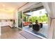 Expansive outdoor living space with a water feature, modern furniture, and outdoor kitchen access at 10313 Jade Point Dr, Las Vegas, NV 89135