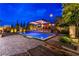 Backyard oasis featuring a sparkling pool with a lounging area and inviting outdoor kitchen and bar at 10313 Jade Point Dr, Las Vegas, NV 89135