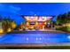 Serene backyard pool with an outdoor kitchen, bar seating and inviting outdoor living area under a pergola at 10313 Jade Point Dr, Las Vegas, NV 89135