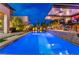 Backyard pool area with outdoor bar seating, outdoor kitchen and basketball hoop, creating a fun and relaxing space at 10313 Jade Point Dr, Las Vegas, NV 89135