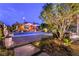 Backyard oasis with a refreshing pool, outdoor kitchen, bar area, and seating for entertaining guests at 10313 Jade Point Dr, Las Vegas, NV 89135