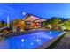 Inviting backyard oasis with a shimmering pool, outdoor kitchen, and comfortable seating area for entertaining at 10313 Jade Point Dr, Las Vegas, NV 89135