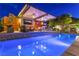 Relaxing pool area with an outdoor kitchen and living space perfect for outdoor enjoyment and entertaining at 10313 Jade Point Dr, Las Vegas, NV 89135