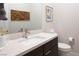 Modern bathroom with white countertop, dark wood vanity and decorative wall art at 11813 Pippa Ave, Las Vegas, NV 89138