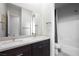Bathroom features a dual sink vanity, large mirror, and tiled shower with glass door at 11813 Pippa Ave, Las Vegas, NV 89138