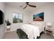 Bright bedroom with a ceiling fan, large window with neighborhood view, and stylish decor at 11813 Pippa Ave, Las Vegas, NV 89138