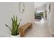 Bright entryway featuring light tile flooring, a modern wood bench, and views into the living room at 11813 Pippa Ave, Las Vegas, NV 89138