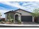 Charming single-story home with a modern design, desert landscaping, and an attached two-car garage at 11813 Pippa Ave, Las Vegas, NV 89138