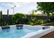 Hot tub with built-in headrests surrounded by lush desert landscaping and a privacy fence at 11813 Pippa Ave, Las Vegas, NV 89138