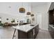 Open-concept kitchen with an island, stainless steel appliances, and seamless flow to dining and living areas at 11813 Pippa Ave, Las Vegas, NV 89138