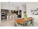Spacious kitchen and dining area featuring modern finishes, stainless steel appliances, and lots of light at 11813 Pippa Ave, Las Vegas, NV 89138