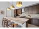 Well-equipped kitchen featuring an island with seating, sleek cabinets, and stainless steel appliances at 11813 Pippa Ave, Las Vegas, NV 89138