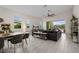 Bright living room with a modern ceiling fan, tile flooring, and large sliding doors to the patio at 11813 Pippa Ave, Las Vegas, NV 89138