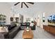 Open-concept living room featuring modern decor, tile flooring, and seamless flow to the kitchen and dining area at 11813 Pippa Ave, Las Vegas, NV 89138