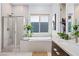 Serene main bathroom showcasing a soaking tub, glass-enclosed shower, and stylish finishes at 11813 Pippa Ave, Las Vegas, NV 89138