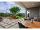 Covered patio overlooking backyard complete with a fire pit, hot tub, bench, and desert landscaping at 11813 Pippa Ave, Las Vegas, NV 89138