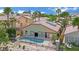 Aerial view of a private home with a sparkling pool, surrounded by lush landscaping and neighborhood at 1324 European Dr, Henderson, NV 89052