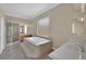 Bathroom with tile flooring, soaking tub, glass-enclosed shower, and double sink vanity at 1324 European Dr, Henderson, NV 89052