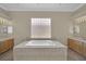 Bathroom boasts a large soaking tub, and sinks, and neutral decor at 1324 European Dr, Henderson, NV 89052