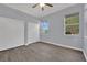 Bedroom with hardwood floors, ceiling fan, two windows, and a double-door closet at 1324 European Dr, Henderson, NV 89052